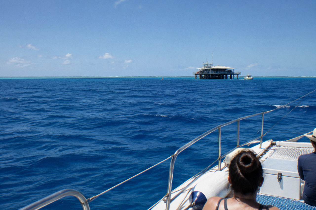 Open blue water beyond the outer Great Barrier Reef line under a clear tropical sky