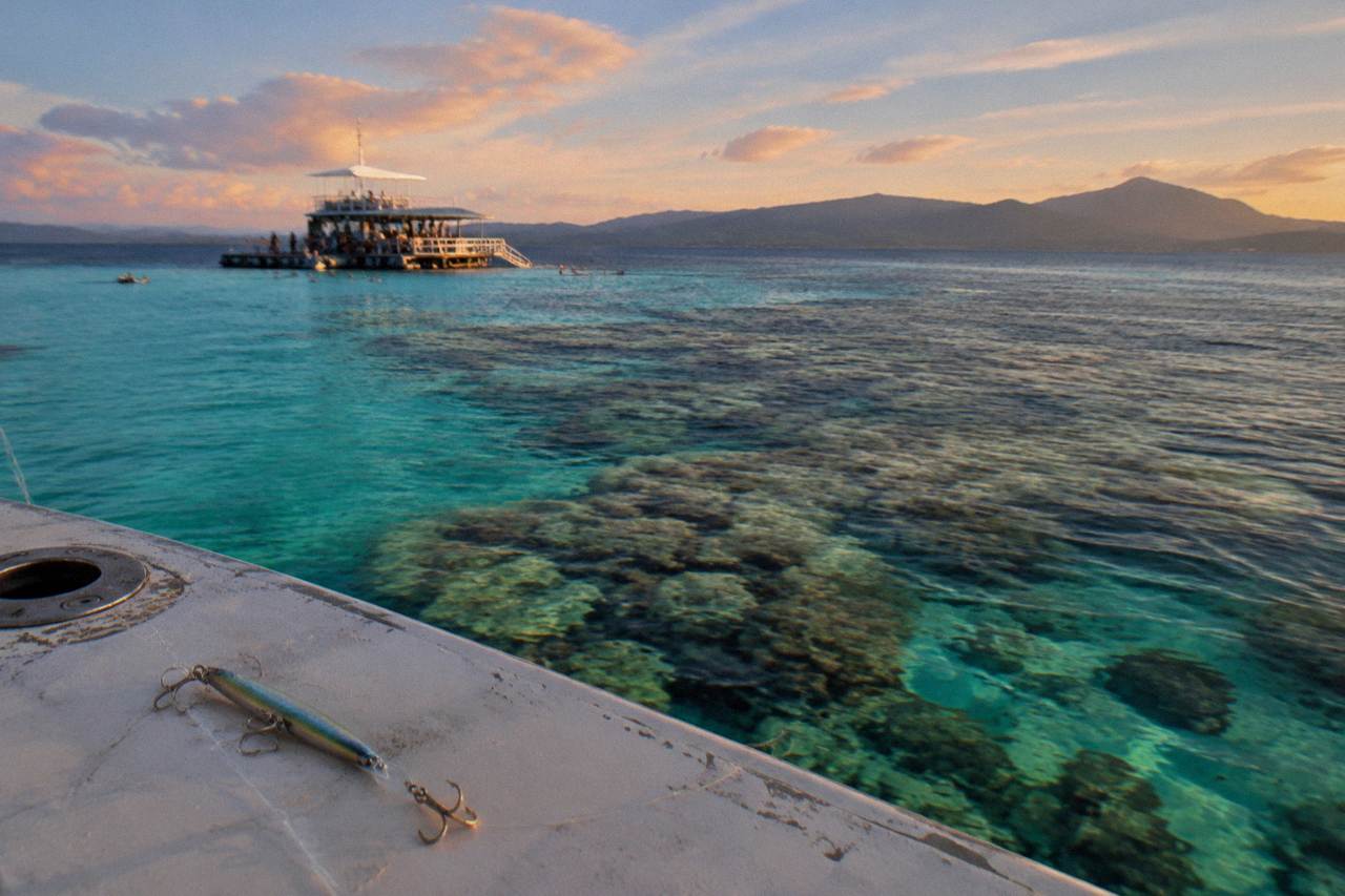 Calm turquoise reef water with coral bommies below the surface near Cairns