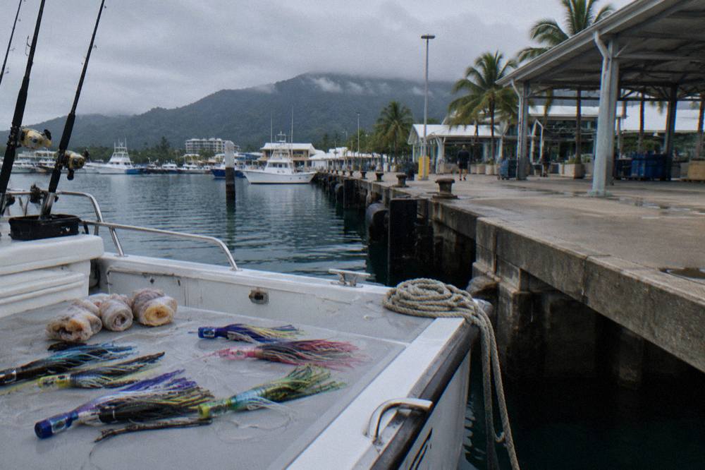 Trolling lures and rigged fishing baits laid out on a game boat deck