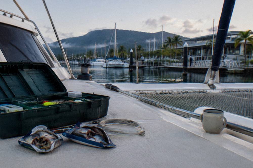 Tackle box and bait arranged on a boat deck
