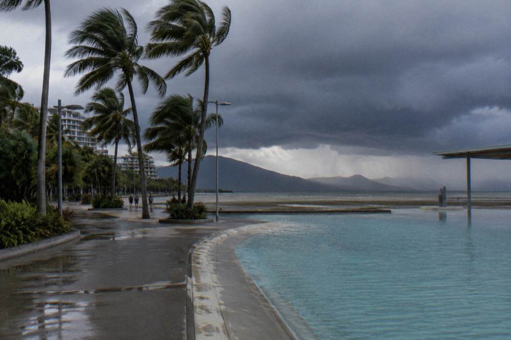 Tropical storm clouds building over calm inshore water in late afternoon